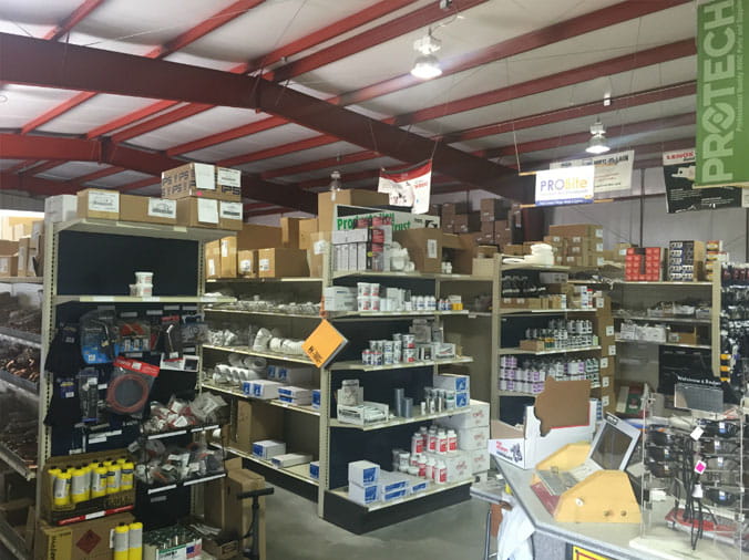 Shelves stocked with plumbing supplies in the Dahl Greeley plumbing warehouse